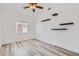 Bright bedroom featuring three floating shelves on the wall and gray wood-look floors at 2617 Tanagrine Dr, North Las Vegas, NV 89084