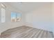 Bright bedroom featuring two windows and gray wood-look flooring at 2617 Tanagrine Dr, North Las Vegas, NV 89084
