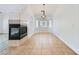 Tile floor dining room featuring modern fireplace, light fixture, and large window at 2617 Tanagrine Dr, North Las Vegas, NV 89084