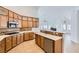 Well-equipped kitchen with wooden cabinets, stainless steel appliances, and tiled backsplash at 2617 Tanagrine Dr, North Las Vegas, NV 89084