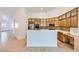 Bright kitchen featuring wooden cabinetry, stainless steel appliances, and a breakfast bar at 2617 Tanagrine Dr, North Las Vegas, NV 89084