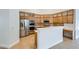 Spacious kitchen featuring stainless steel appliances, wooden cabinets, and tile flooring at 2617 Tanagrine Dr, North Las Vegas, NV 89084