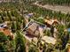 Aerial view of the home showcasing its setting amongst the surrounding tall evergreen trees at 264 Crestview Dr, Las Vegas, NV 89124