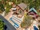 The house has a unique stone facade, tiered landscaping, and is set among tall trees at 264 Crestview Dr, Las Vegas, NV 89124