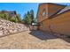 View of the backyard with stone retaining wall and covered area with a patio at 264 Crestview Dr, Las Vegas, NV 89124