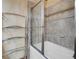 Tiled shower and tub featuring glass shelving and chrome hardware in this bathroom at 264 Crestview Dr, Las Vegas, NV 89124