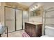 Bathroom with a walk-in shower, modern vanity with a dark wood finish, and tile flooring at 264 Crestview Dr, Las Vegas, NV 89124