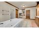 Spacious bathroom features a soaking tub, walk-in shower, wooden cabinets, and a decorative fireplace at 264 Crestview Dr, Las Vegas, NV 89124