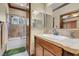 Well-lit bathroom features tiled shower and tub, vanity with decorative trim and mirror at 264 Crestview Dr, Las Vegas, NV 89124