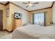 Bedroom featuring marble flooring, accent walls, wood trim and ceiling fan at 264 Crestview Dr, Las Vegas, NV 89124