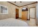 Bedroom featuring wood trim and flooring, accent walls and ensuite bathroom at 264 Crestview Dr, Las Vegas, NV 89124