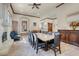 Elegant dining room with a large stone table, ornate fireplace, and decorative wood trim at 264 Crestview Dr, Las Vegas, NV 89124