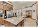 Gourmet kitchen with granite counters, custom cabinets, and stainless steel refrigerator at 264 Crestview Dr, Las Vegas, NV 89124