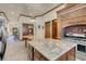 Open kitchen featuring granite countertop island, custom cabinetry, and access to other rooms at 264 Crestview Dr, Las Vegas, NV 89124