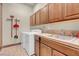 Functional laundry room with tile floor, sink, wood cabinets, and a washer and dryer at 264 Crestview Dr, Las Vegas, NV 89124