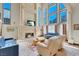 Bright living room with high ceilings, a stone fireplace, and views of the mountains at 264 Crestview Dr, Las Vegas, NV 89124
