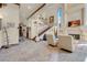 Elegant living room with high ceilings, a stone fireplace, and staircase with iron railings at 264 Crestview Dr, Las Vegas, NV 89124