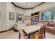 Living room with a large built-in bookcase, window seating, and tile floors at 264 Crestview Dr, Las Vegas, NV 89124