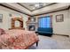 Spacious main bedroom with a stone fireplace, beamed ceilings, and a comfortable sitting area at 264 Crestview Dr, Las Vegas, NV 89124
