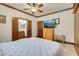 Bright main bedroom featuring wood trim, ceiling fan and ensuite bathroom with double sink at 264 Crestview Dr, Las Vegas, NV 89124