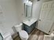 Bathroom featuring a white toilet and vanity with gray cabinet at 2964 Juniper Hills Blvd # 202, Las Vegas, NV 89142