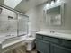 Bathroom showcasing bathtub with shower and vanity with a gray cabinet at 2964 Juniper Hills Blvd # 202, Las Vegas, NV 89142