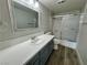 Bright bathroom features vanity with white countertop and gray cabinet at 2964 Juniper Hills Blvd # 202, Las Vegas, NV 89142