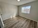 Well-lit bedroom with wood-look flooring and a window with privacy blinds at 2964 Juniper Hills Blvd # 202, Las Vegas, NV 89142