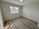 Well-lit bedroom showcasing wood-look flooring and a window with blinds at 2964 Juniper Hills Blvd # 202, Las Vegas, NV 89142