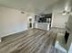 Living room with new wood flooring, fireplace, and adjacent kitchen at 2964 Juniper Hills Blvd # 202, Las Vegas, NV 89142