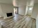 Open floor plan with new wood flooring, fireplace, and sliding door at 2964 Juniper Hills Blvd # 202, Las Vegas, NV 89142