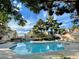 Exterior shot of the community pool with blue water and surrounding buildings at 2964 Juniper Hills Blvd # 202, Las Vegas, NV 89142