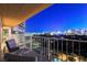Relax on this comfortable balcony, offering seating and stunning panoramic views of the vibrant city skyline at 3111 Bel Air Dr # 12C, Las Vegas, NV 89109