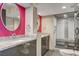 Modern bathroom with double sinks, granite countertops, and a glass shower at 3111 Bel Air Dr # 12C, Las Vegas, NV 89109