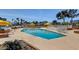 Resort-style pool with umbrellas, lounge chairs and manicured grounds at 3111 Bel Air Dr # 12C, Las Vegas, NV 89109