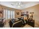 Bedroom with sporty theme features a ceiling fan, natural light and neutral paint at 3625 N Campbell Rd, Las Vegas, NV 89129