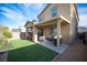 Inviting backyard featuring artificial grass and a covered patio, ideal for outdoor entertaining and relaxation at 3746 Bright Aquarius Ln, Henderson, NV 89052