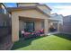 Cozy backyard patio with a covered area, complete with stylish outdoor furniture and a lush lawn at 3746 Bright Aquarius Ln, Henderson, NV 89052