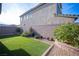 Well-maintained backyard featuring artificial turf, complemented by stone landscaping and greenery at 3746 Bright Aquarius Ln, Henderson, NV 89052