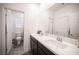Bright bathroom featuring double sinks and a large mirror at 3746 Bright Aquarius Ln, Henderson, NV 89052