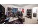 Nicely decorated bedroom featuring large bookshelves, carpeted floor, and a gaming computer setup at 3746 Bright Aquarius Ln, Henderson, NV 89052