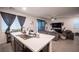 Bright, open kitchen with a large island flows into the living area, perfect for entertaining at 3746 Bright Aquarius Ln, Henderson, NV 89052