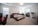 Spacious main bedroom featuring carpet, a large bed, and large windows at 3746 Bright Aquarius Ln, Henderson, NV 89052