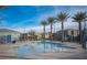 Community pool on a sunny day with lounge chairs and palm trees around at 3746 Bright Aquarius Ln, Henderson, NV 89052