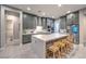 Contemporary kitchen featuring gray cabinets, a center island with seating, and stainless steel appliances at 415 Point Sur Ave, Las Vegas, NV 89138