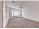 Primary bedroom features neutral carpet, a ceiling fan, and a bay window at 473 Elm Crest Pl, Henderson, NV 89012