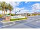 Sun City MacDonald Ranch entrance with lush landscaping, mountain views, and clear signage for residents and visitors at 473 Elm Crest Pl, Henderson, NV 89012