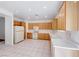 Traditional kitchen featuring tile floors, bright white countertops, and abundant wood cabinetry at 473 Elm Crest Pl, Henderson, NV 89012