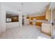 Open-concept kitchen featuring tile floors, wood cabinetry, and a view to the adjacent living area at 473 Elm Crest Pl, Henderson, NV 89012