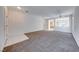 Large living room with tiled entry, neutral carpet, and a view into the kitchen at 473 Elm Crest Pl, Henderson, NV 89012